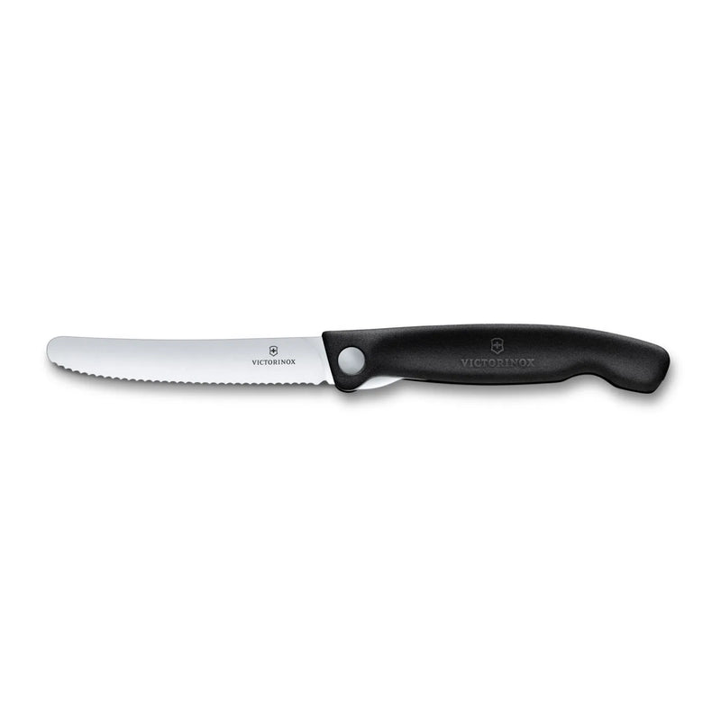 Victorinox Swiss Classic foldable paring knife in black, fully open side view showing the serrated wavy-edge blade and handle