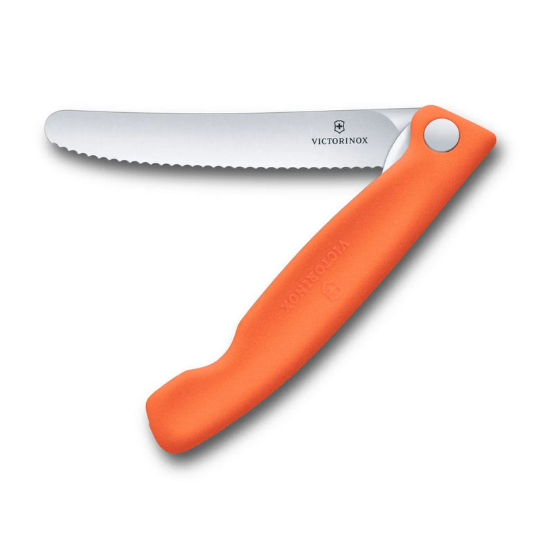 Victorinox Swiss Classic foldable paring knife in tangerine orange, opened flat with the 11 cm serrated blade extended, seen from above