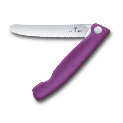 Victorinox Swiss Classic foldable paring knife in eggplant purple, opened flat with the 11 cm serrated blade extended, seen from above