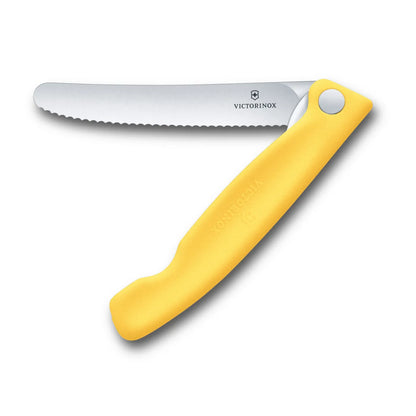 Victorinox Swiss Classic foldable paring knife in lemon yellow, opened flat with the 11 cm serrated blade extended, seen from above